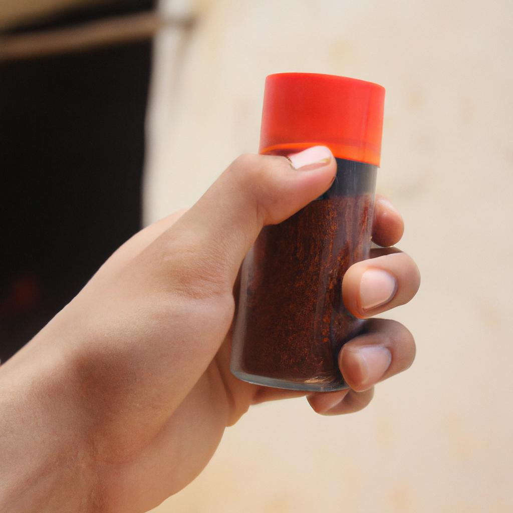 Person holding chili powder container