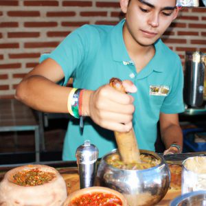 Person cooking Mexican food, smiling